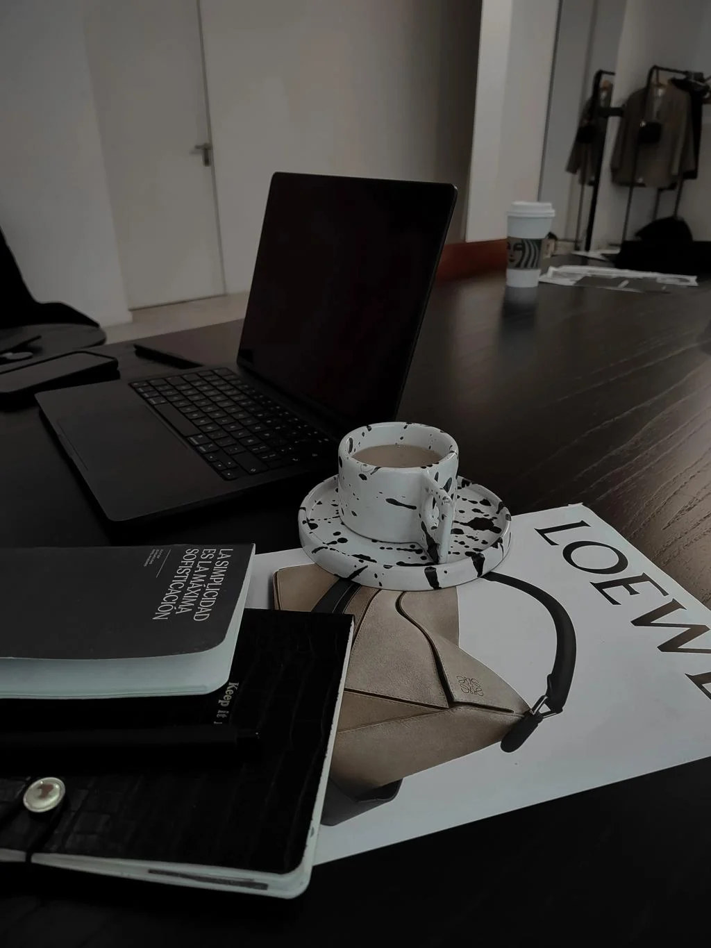 Editorial creator workspace with laptop, coffee and magazine